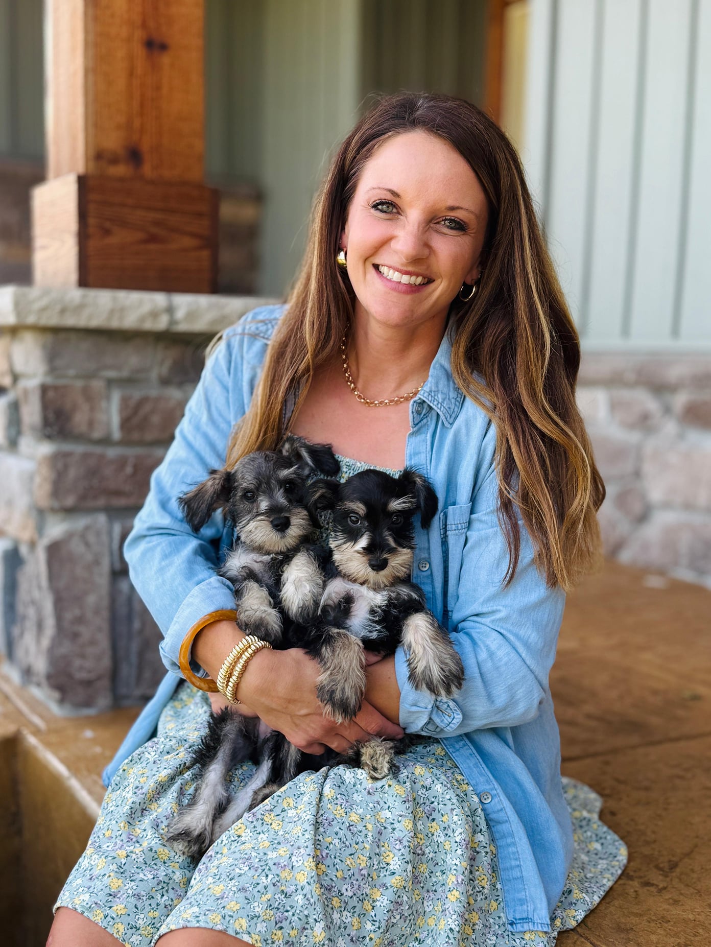 Erica Wysong holding two Fernweh Scnauzer puppies